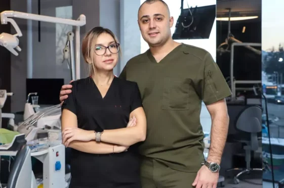 Двама стоматолози, мъж и жена, позиращи за снимка в стоматологична клиника.